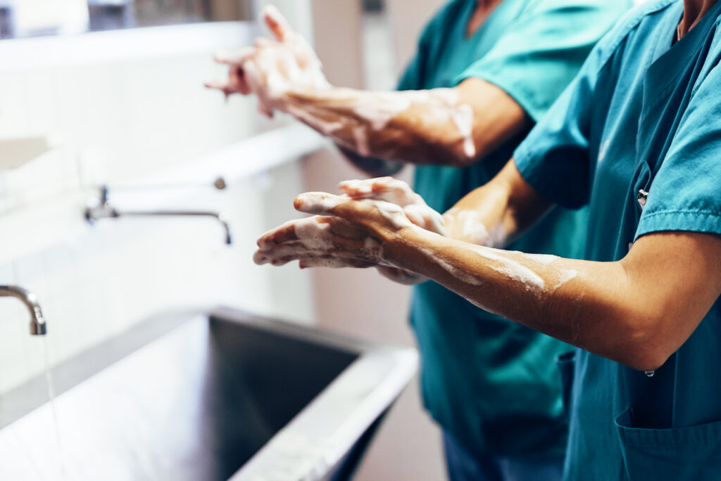 couple of surgeons washing hands before operating.