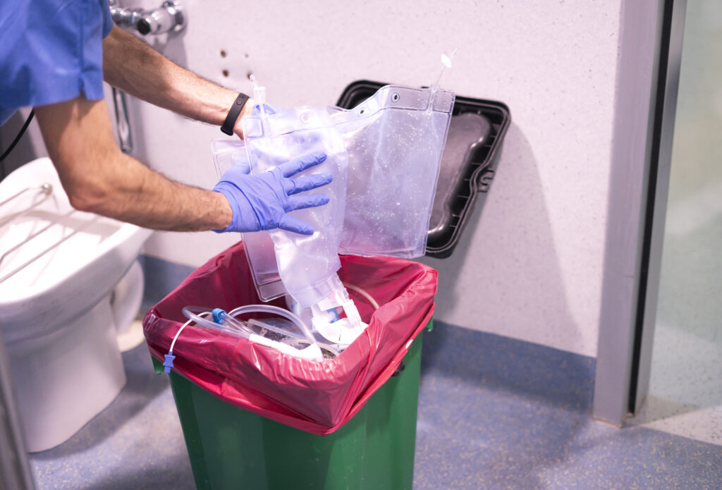 nurse discarding medical waste in hospital room